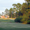 A view of the 6th hole at Diamondhead Country Club - Cardinal Course with clubhouse and deers in background