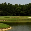 A view of the 12th hole surrounded by water at Oaks Golf Club
